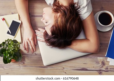 Woman Sleeping On The Workplace. Tired Woman Asleep On Office Desk. Toned Photo