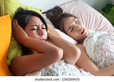 Woman Sleeping And Snoring Out Loud, Waking Her Roommate Up. Concept Of Sleeping Disorder, Snoring Problem