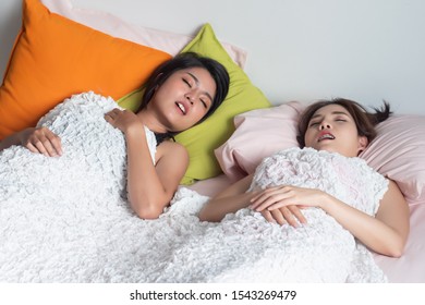 Woman Sleeping And Snoring Out Loud, Waking Her Roommate Up. Concept Of Sleeping Disorder, Snoring Problem