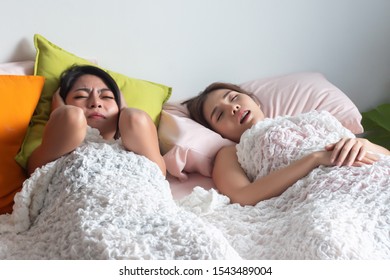 Woman Sleeping And Snoring Out Loud, Waking Her Roommate Up. Concept Of Sleeping Disorder, Snoring Problem