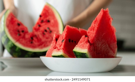 Woman with slice of fresh watermelon at kitchen, closeup - Powered by Shutterstock