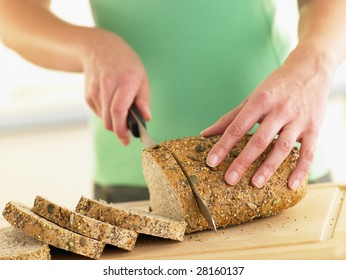 Woman Slicing Mixed Grain Bread