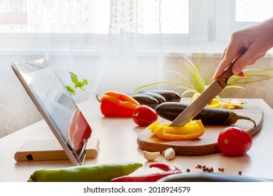 Woman Slicing Pepper Watching Online Culinary Class Her Tablet, Cooking Vegan Food With Fresh Vegetables.