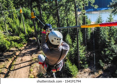Woman sliding on a zip line in an adventure park - Shutterstock ID 154191794
