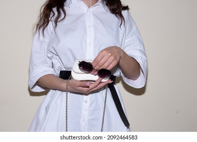 Woman In Small White Bag In Hand