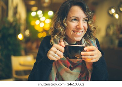 Woman With Smart Phone In Coffee Shop