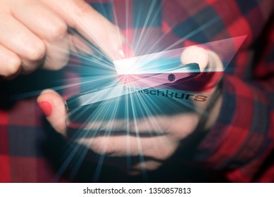 A Woman With A Smart Phone, A Polish Flag And A German Translation Of A Polish Language Course