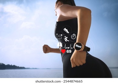 Woman with smart watch running near river outdoors, closeup. Low angle view. Icons near device