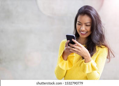 Woman with smartphone in downtown city street
 - Shutterstock ID 1532790779