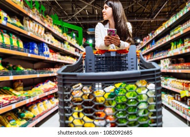 woman with smartphone in store. grocery shopping. gadgets and shopping. - Powered by Shutterstock