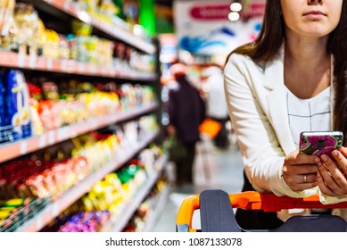 woman with smartphone in store. grocery shopping. gadgets and shopping. - Powered by Shutterstock