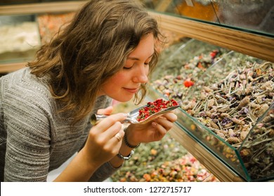 Woman Smell Aromatic Herbal Tea Leaves From All The World On Grand Bazaar In Istanbul, Turkey