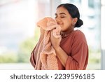 Woman smelling clean laundry, blanket or fabric for fresh and clean smell in house after doing washing, cleaning and housekeeping. Happy female cleaner with textile for aroma, fragrance and scent