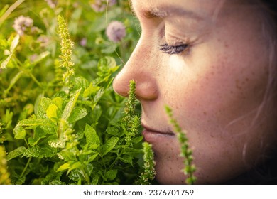 Woman smelling mint. Love for mint. Mint in the garden. - Powered by Shutterstock