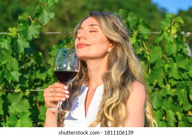 Woman Smelling Wine Aroma Taste. Happy Girl Drinking Wine. Beauty Lady With A Glass Of Wine Dreamy Looks