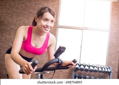 Woman Smile Happily And Use Exercise Bike
