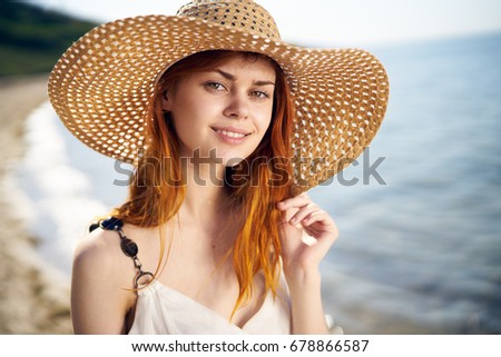 Woman with a smile in the hat on the seaside portrait                               