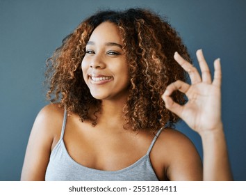 Woman, smile and ok sign with studio portrait, emoji and decision with agreement by background. Girl, person and model with pride with icon, symbol and happy for choice with confidence in Costa Rica - Powered by Shutterstock