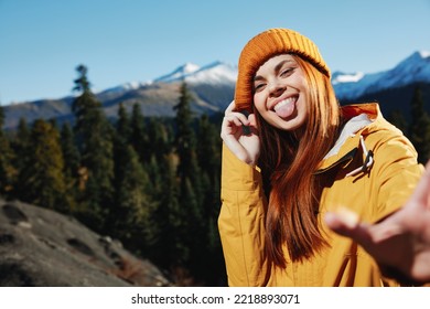 Woman Smile With Teeth Showing Tongue Hiker Portrait In Yellow Raincoat Travel In The Fall And Hiking In The Mountains In The Sunset Sun Free