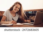 Woman, smile and writing at cafe with laptop as university student for elearning or online education. Female learner, happy and satisfied with studying or revision and research for college exams
