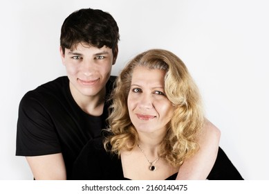 The Woman Smiles And Is Happy That She Has Such An Adult Son Who Hugs Her And Thanks For Everything, For The Love Of Understanding And Patience For Him. Mom And Son Teen. Focus On The Woman