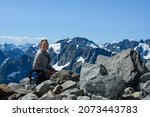 Woman Smiles from Summit of Sahale Arm in Washington wilderness
