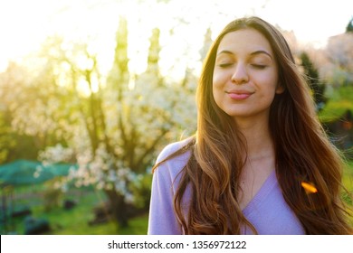 Woman smiling with closed eyes taking deep breath celebrating freedom. Positive human emotion face expression feeling life perception success peace mind concept. Free Happy girl enjoying nature. - Powered by Shutterstock