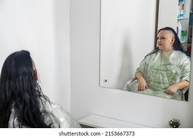 Woman Smiling With Half Shaved Head In Barber Chair Reflected In Mirror. Horizontal Photo