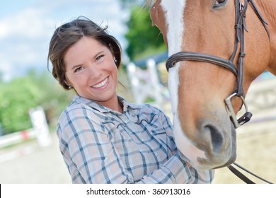 Woman Smiling With A Horse