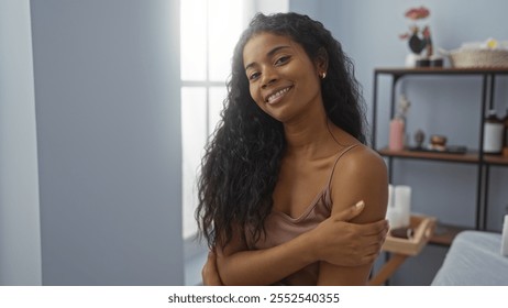 Woman smiling indoors in a wellness center, showcasing a calm and peaceful atmosphere with soft lighting - Powered by Shutterstock