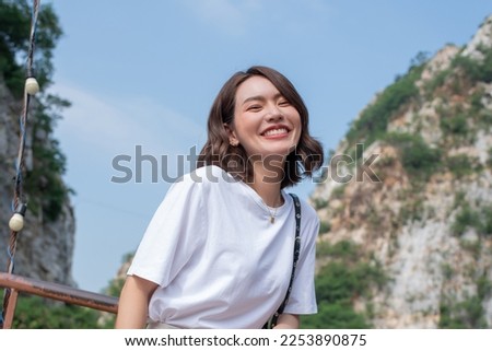 Woman smiling with perfect smile and white teeth in a park and looking at camera, Portrait of beautiful woman smiling and looking away at park during sunset. Happy cheerful girl laughing at park.