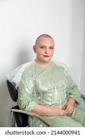 Woman Smiling With Shaved Head In Barber Chair. Vertical Photo