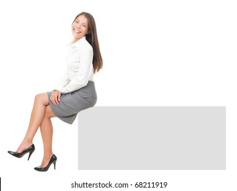 Woman smiling sitting on horizontal banner edge. Happy businesswoman showing sign with lot of copy space. Isolated on white background in full body. - Powered by Shutterstock