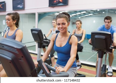 Woman Smiling At Spinning Class In Gym