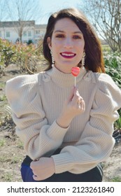 Woman Smiling While Holding Heart Sucker