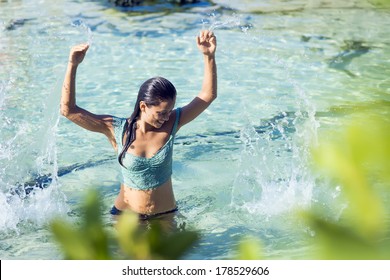 Woman smiling while swimming in cristal clear watter