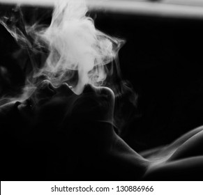 Woman Smokes In The Dark