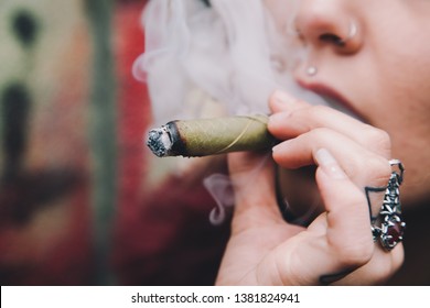 Woman smoking cannabis cigar at a festival