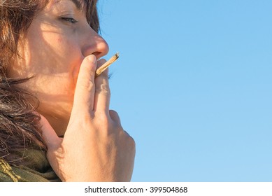 Woman Smoking A Cigarette Joint