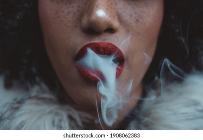 Woman smoking, close up on smoke and mouth