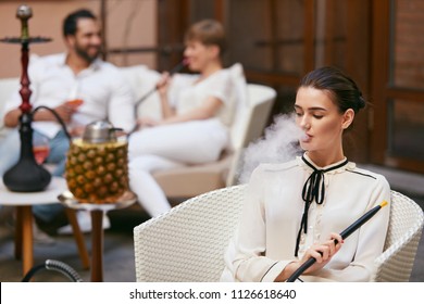 Woman Smoking Shisha In Hookah Bar