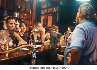 Woman Smoking Shisha With Hookah Pipe In Bar