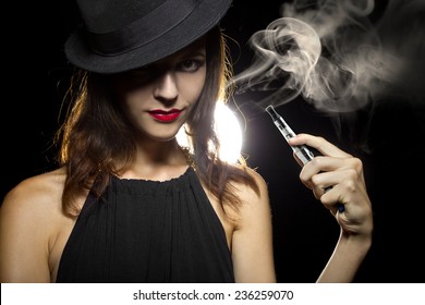 woman smoking or vaping an electronic cigarette to quit tobacco