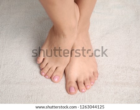 Woman with smooth feet on towel, closeup. Spa treatment
