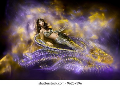 Woman in snake fantasy dress. Snake fashion stylish. Abstract background. Artwork