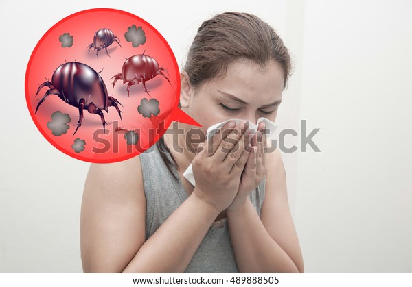Woman sneeze rashes, allergy to dust mites. Dust\
mites illustrated\
concept.