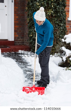 Woman with snow shovel