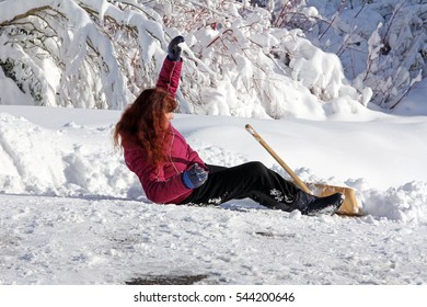 A Woman Is With The Snow Shovel Fallen Down. Wintery Accident