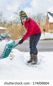 Woman Snow Shoveling Driveway