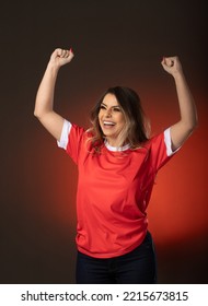 woman soccer fan cheering for her favorite club and team. world cup red background. - Shutterstock ID 2215673815